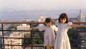 Gazal and Sonal posing at the terrace of our apartment building, with the Arabian Sea in the background